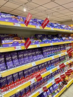 Aisle Prints: 30.10.2025 Ukraine, Kharkov, Chocolate Bars on Supermarket Shelves with Promotional Discount Tags
