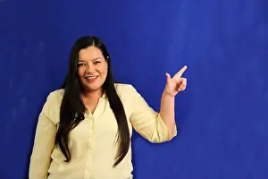 Optimistic Prints: 40-year-old Latina woman points with the fingers of her hand to something that she likes