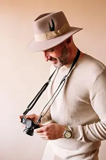 Behind Prints: 45 year old man with modern digital camera