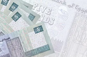 Funds Prints: 5 Egyptian pounds bills lies in stack on background of big semi-transparent banknote