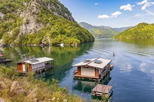 Untouched Prints: 5 September 2025, Perucac, Serbia: Floating wooden house on the Drina River with surrounding mountains