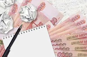 Lack Prints: 5000 russian rubles bills and balls of crumpled paper with notepad