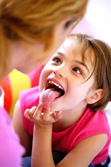 Sticking Prints: 6 year old girl showing her tongue