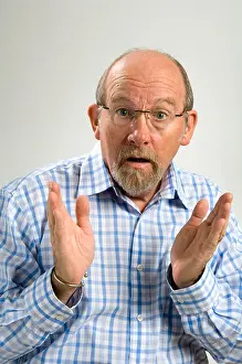 60 year old white man with a goatee beard and a facial expression depicting mystification