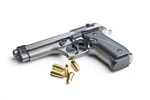 Cartridge Prints: 9mm pistol bullets and handgun isolated on white background