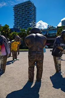 A-maze-ing Laughter statues with one wearing a Team Australia Socceroos jersey by English Bay during the 2026 World Cup
