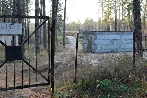Forbidden Prints: Abandoned concrete building in the forest with barbed wire fence