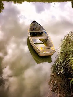 Reeds Prints: Abandoned row boat on the river Alde in Snape, Suffolk