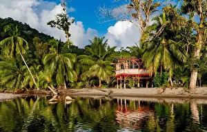 Waters Edge Prints: An abandoned shack being reflected in the water on the beach at Grand Riviere on the tropical Caribbean island of