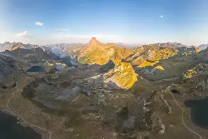 Golden Light Prints: From above, an aerial view captures the majestic Lacs d'Ayous in the French Pyrenees during sunrise