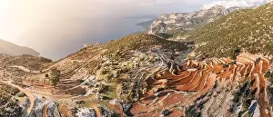 From above, the mesmerizing sight of a plowed field with terraces on the hills unfolds