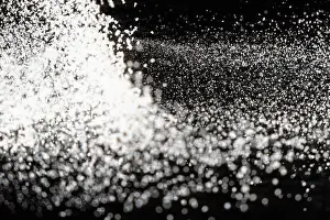 Scattered Prints: Abstract black and white background of pouring flour, space for text
