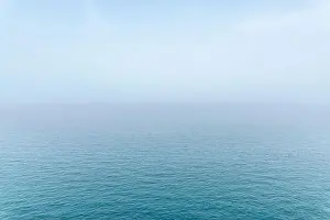 Light Blue Prints: Abstract infinity sea view with small wave pattern and fog on horizon