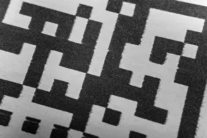 Inventory Prints: Abstract monochrome close up of isolated printed QR data matrix bar code on white paper label background from material