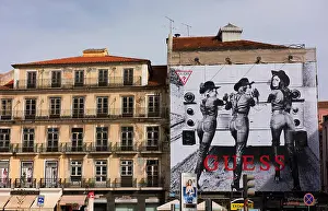 Guess Prints: Advertisement for Guess women's jeans on the side of a building in Lisbon