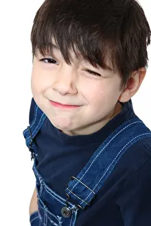 Flirt Prints: Adorable six year old caucasian boy in overalls winking at camera