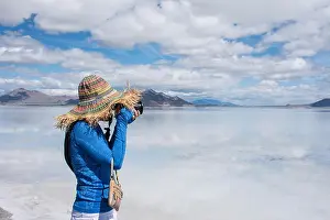 Salt Flats Prints: Adult female wearing a straw hat wanders around the Bonneville Salt Flats in Utah