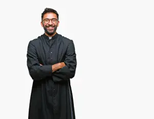 Crossed Prints: Adult hispanic catholic priest man over isolated background happy face smiling with crossed arms looking at the camera