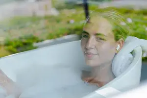 Reclining Prints: Adult woman resting in bathroom tub by window