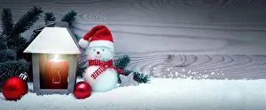 White Christmas Prints: Third Advent. Christmas lantern and snowman with santa claus hat on white snow