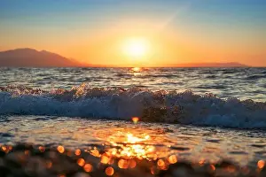 Crashing Prints: Aegean sea wave crashing at sandy beach of Vrasna, Greece. Selective focus