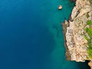 Aerial bird's eye view of cliffs and turquoise sea in Antalya Turkey