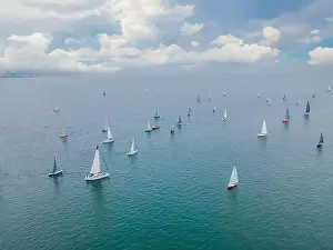 Luxury Yacht Prints: Aerial bird's eye view photo taken by drone of sailboat in turquoise sea water