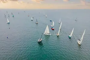 Luxury Yacht Prints: Aerial bird's eye view photo taken by drone of sailboat in turquoise sea water