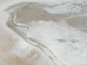 Aerial close up of the surface of the huge salt flats Salinas Grandes de Jujuy in northern Argentina while traveling