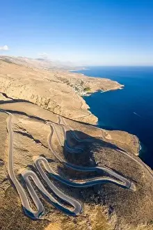 Bending Prints: Aerial coastal view of the winding road between the towns of Hora Skafion and Anopolis on the south coast of Crete