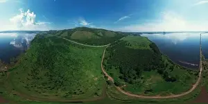 Aerial drone 360 panorama view of lake landscape with road in sunny summer