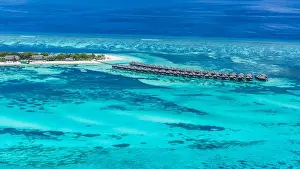 Aerial drone bird's eye view photo of Maldives island and sea. Beautiful turquoise and sapphire clear water beach. Exotic vacation from seaplane view