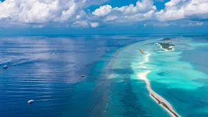 Aerial drone bird's eye view photo of Maldives island and sea. Beautiful turquoise and sapphire clear water beach. Exotic vacation from seaplane view