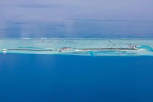 Aerial drone bird's eye view photo of Maldives island and sea. Beautiful turquoise and sapphire clear water beach. Exotic vacation from seaplane view