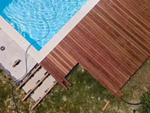 Laziness Prints: aerial drone flight over beautiful green garden with pool and the wooden deck of the pool is in progress