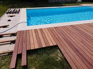 Laziness Prints: aerial drone flight over beautiful green garden with pool and the wooden deck of the pool is in progress
