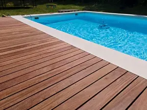 Laziness Prints: aerial drone flight over beautiful green garden with pool and the wooden deck of the pool is in progress