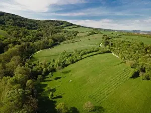 Hill Spring Prints: aerial drone flight over green meadows and forest in lower austria
