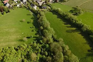 aerial drone flight over green meadows and forest in lower austria