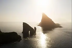 Aerial drone flying over Drangarnir and Tindholmur sea stacks