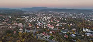 Business Finance And Industry Prints: Aerial drone image of the cityscape of Uzhhorod Ukraine during sunset high mountains during sunset