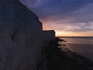 Seven Sisters Prints: Aerial Drone Landscape photo of a Beachy Head Lighthouse and chalk cliffs at colorful sunrise with low tide in England