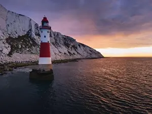 Seven Sisters Prints: Aerial Drone Landscape photo of a Beachy Head Lighthouse and chalk cliffs at colorful sunrise with low tide in England