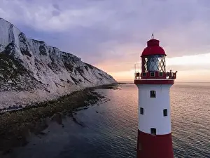 Seven Sisters Prints: Aerial Drone Landscape photo of a Beachy Head Lighthouse and chalk cliffs at colorful sunrise with low tide in England