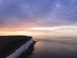 Seven Sisters Prints: Aerial Drone Landscape photo of a Beachy Head Lighthouse and chalk cliffs at colorful sunrise with low tide in England