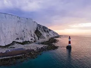 Seven Sisters Prints: Aerial Drone Landscape photo of a Beachy Head Lighthouse and chalk cliffs at colorful sunrise with low tide in England