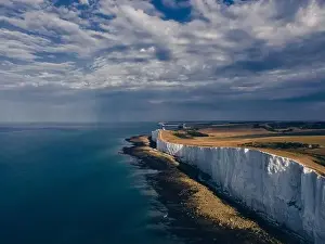 Seven Sisters Prints: Aerial Drone Landscape photo of a Beachy Head Lighthouse and chalk cliffs at colorful sunrise with low tide in England