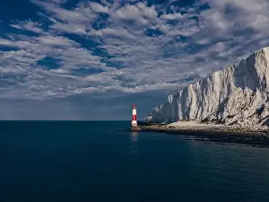 Seven Sisters Prints: Aerial Drone Landscape photo of a Beachy Head Lighthouse and chalk cliffs at colorful sunrise with low tide in England