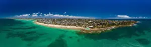 Aerial drone panoramic image of ocean waves on a busy Kings beach, Caloundra, Queensland, Australia