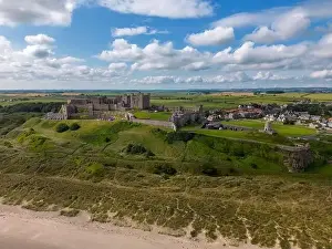 English Coast Prints: Aerial drone photo of Bamburgh Castle at the beautiful coastline of Northumberland